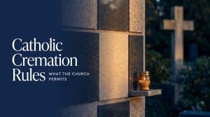 Catholic cremation rules guide: a columbarium niche in a Catholic cemetery with a name plate and candle